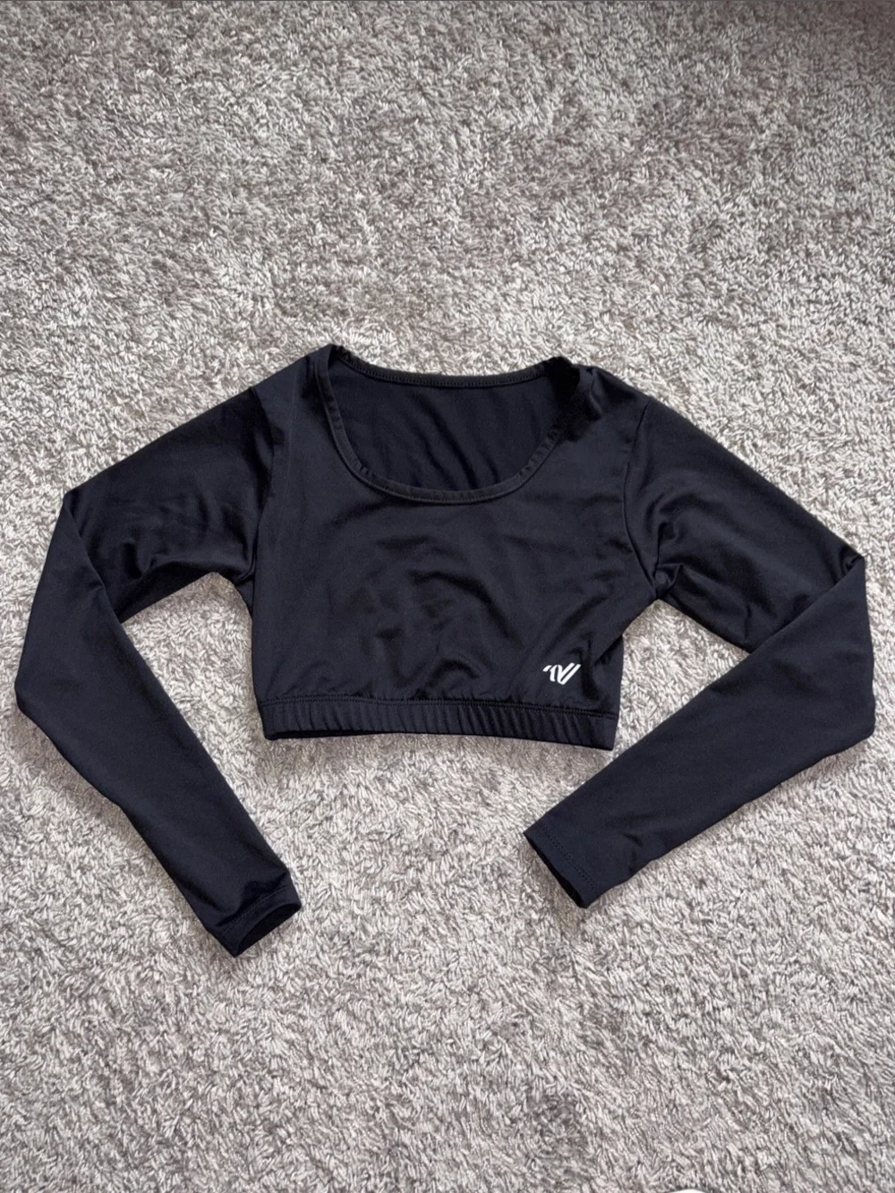 Varsity Black Long-Sleeve Cropped Athletic Top. Scoop neck liner. SSMSC15